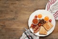 Plate of fried eggs, mushrooms, beans, bacon, tomatoes and toast on wooden table, flat lay with space for text. Traditional Royalty Free Stock Photo