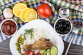 Plate with fried legs, rice, vegetable, lemons, black olives Royalty Free Stock Photo