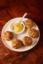 Plate of fried meatballs with mustard dip Royalty Free Stock Photo