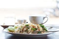 A plate of fried rice and a cup of latte coffee on wooden table Royalty Free Stock Photo