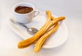 Plate of fried Spanish Churros topped with sugar and hot chocolate sauce Royalty Free Stock Photo