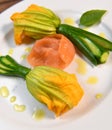 Plate with fried zucchini flowers with a slice of smoked salmon Royalty Free Stock Photo
