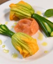 Plate with fried zucchini flowers with a slice of smoked salmon Royalty Free Stock Photo