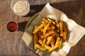 Plate of fries with ketchup and glass of dark beer