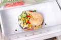 Plate with frozen meat and vegetables in the freezer. Concept of saving time on cooking dinner and convenience of ready made Royalty Free Stock Photo