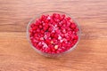 Plate frozen red currants on a wooden background. Harvesting of berries for the winter. Royalty Free Stock Photo