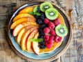 A plate of fruit with a blue plate and a wooden table Royalty Free Stock Photo