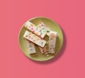 Plate with fruit marshmallow on a pink background