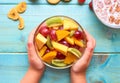 Plate with fruit salad in the hands of the child Royalty Free Stock Photo