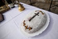 A plate full with coliva, Romanian traditional cake made from boiled wheat used at funeral ceremonies, decorated with a christian