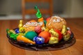 Plate full of Easter treats - candies, muffins and colored eggs