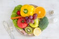 Plate full of fruits and vegetables, cutlery, spices. Healthy meal