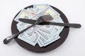 Plate full hundreds of dollar bills with fork and knife. Concept of prosperity and abundance. Full plate concept. Copy space Royalty Free Stock Photo