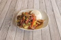 Plate full of typical Peruvian lomo saltado recipe accompanied by rice, peppers and red onion and homemade chips Royalty Free Stock Photo