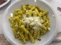 plate of fusilli pesto pasta with parmesan cheese