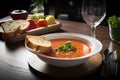 plate of gazpacho, served with crusty bread and glass of chilled white wine