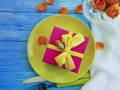 Plate, gift box, romantic flower rose on a blue wooden background Royalty Free Stock Photo