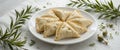 Golden Brown Flaky Pastries on White Plate with Fresh Herbs Royalty Free Stock Photo