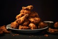 A plate of golden crispy fried chicken wings on minimal black background. Tasty junk food concept