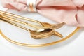 Plate with golden cutlery and napkin on table, closeup Royalty Free Stock Photo