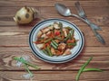 A plate of green beans and other vegetables, as well as chicken on a wooden background Royalty Free Stock Photo