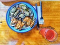 A plate of green lipped mussells and glass of juice on a wooden table in New Zealand Royalty Free Stock Photo