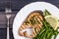 Plate of grill salmon fish with salad and fork top view closeup Royalty Free Stock Photo