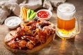 Plate of grilled chicken wings and mug of beer Royalty Free Stock Photo