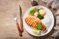 plate of grilled salmon steak, rice and vegetables, top view Royalty Free Stock Photo