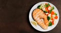 Plate of grilled salmon steak with vegetables, top view Royalty Free Stock Photo