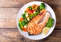 Plate of grilled salmon steak with vegetables Royalty Free Stock Photo