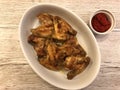 Roasted chicken wings with parsley and Sauce on plate
