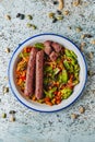 Plate with grilled veggie sausages and vegetables