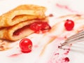 Plate with half-eaten pancakes with berry jam