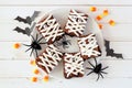 Plate of Halloween mummy brownies, top view with decor on white wood