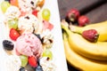 Plate of healthy fresh fruit salad with ice cream on the wooden background Royalty Free Stock Photo