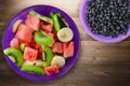 Plate of healthy fresh fruit salad on wooden background Royalty Free Stock Photo