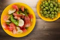 Plate of healthy fresh fruit salad on wooden background Royalty Free Stock Photo