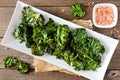 Plate of healthy organic kale chips, top view on wood