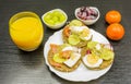 A plate with healthy rye bread sandwiches, fruit and juice for b Royalty Free Stock Photo