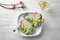 Plate with healthy toasts on white wooden table