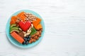 Plate with heart-healthy products on wooden background Royalty Free Stock Photo