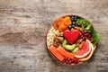 Plate with heart-healthy products on wooden background, top view. Royalty Free Stock Photo