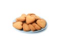 Plate with heart shaped cookies isolated on background