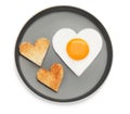 Plate with heart shaped fried egg and toasts isolated on white, top view Royalty Free Stock Photo