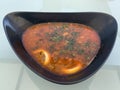 A plate of hodgepodge on a white table. First dish with meat and vegetables. Soup with herbs and lemon Royalty Free Stock Photo