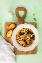 A plate of homemade Minestrone soup with meatballs and spinach on a green background. Royalty Free Stock Photo