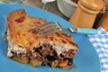 Plate of homemade moussaka with fork close-up