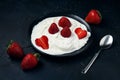 Plate with ice cream and strawberries on a dark blue background. Sweet dessert from fresh berries on table Royalty Free Stock Photo