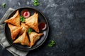 Plate with indian samosas on black stone background. Generative AI